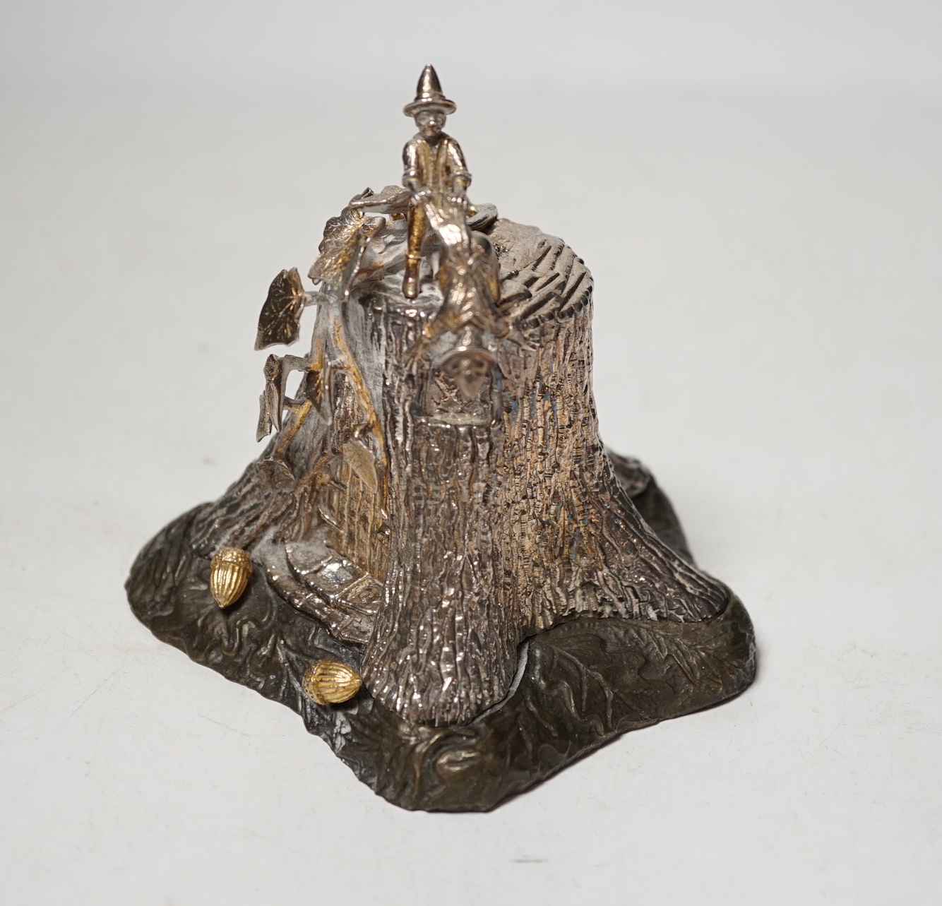 A limited edition Elizabeth II parcel gilt silver and base metal model by Christopher Nigel Lawrence, depicting pixies upon a tree stump, opening to reveal mice in kitchen scene, numbered 20/250, height 11.2cm.